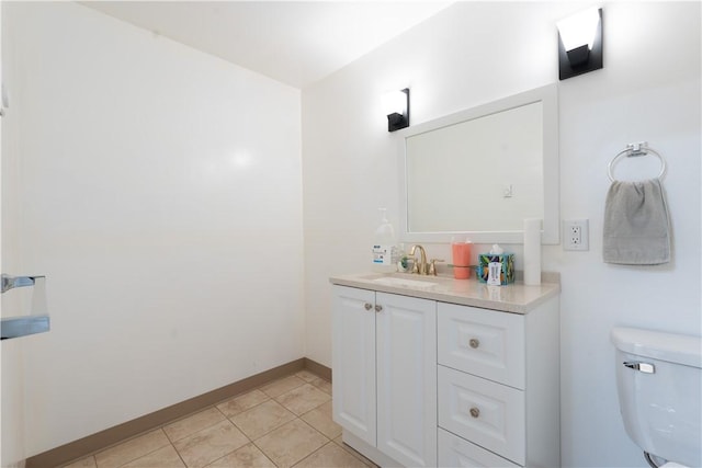 bathroom featuring vanity, tile patterned floors, toilet, and baseboards