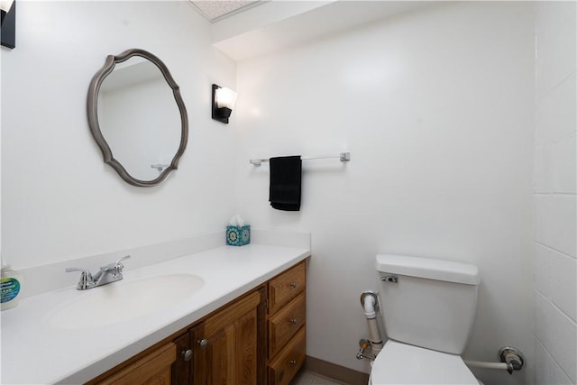 bathroom featuring toilet and vanity