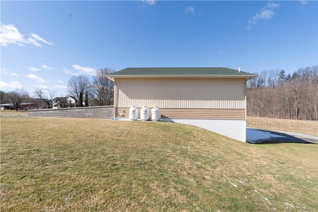 view of side of home featuring a lawn