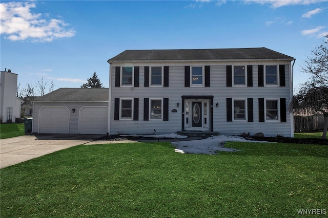 colonial house with driveway, a front yard, and an attached garage