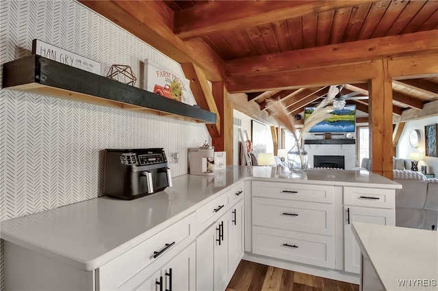 kitchen featuring a ceiling fan, open floor plan, white cabinetry, a peninsula, and light countertops