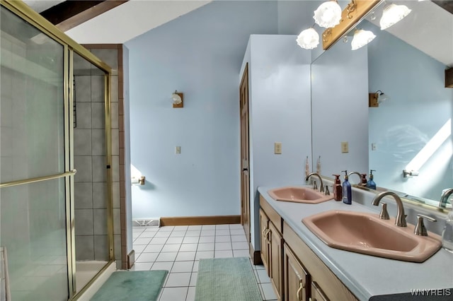 bathroom with tile patterned flooring, a stall shower, and a sink