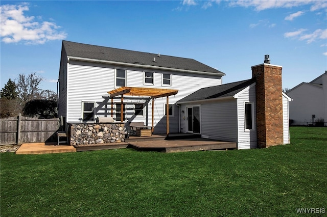 back of property featuring fence, a lawn, a chimney, a deck, and a pergola