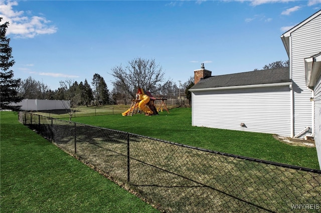 view of yard featuring a playground and fence