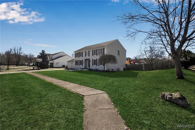 view of front of home with a front lawn and fence