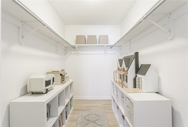 walk in closet featuring light wood-style floors