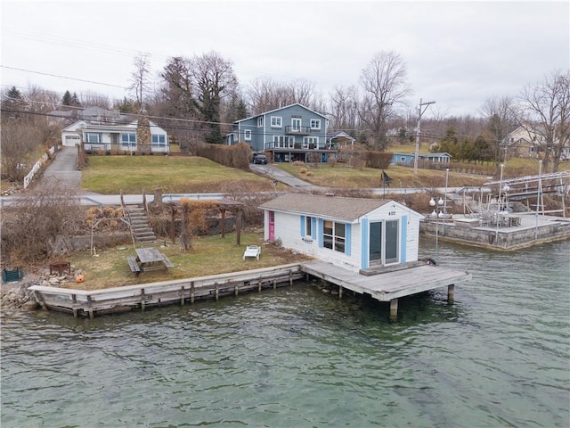 dock area featuring a lawn and a water view