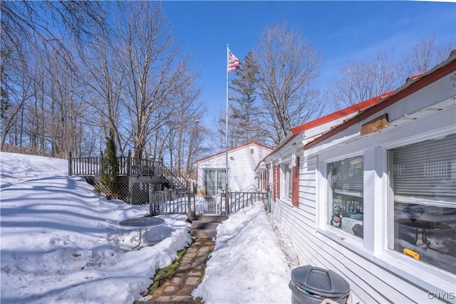 snow covered property featuring a deck