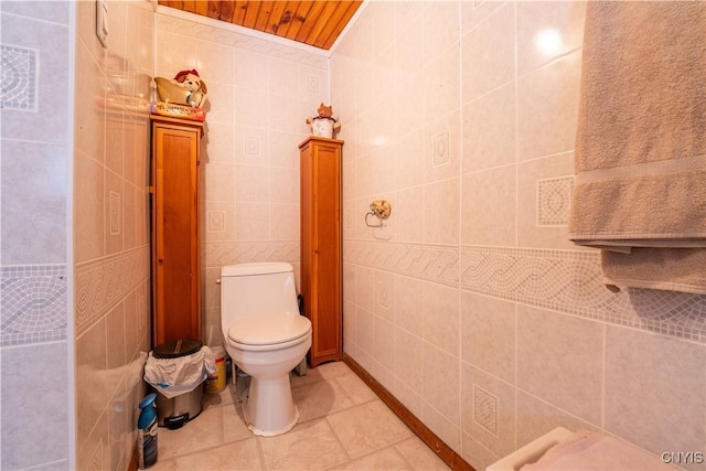 bathroom featuring tile patterned floors, visible vents, toilet, and tile walls