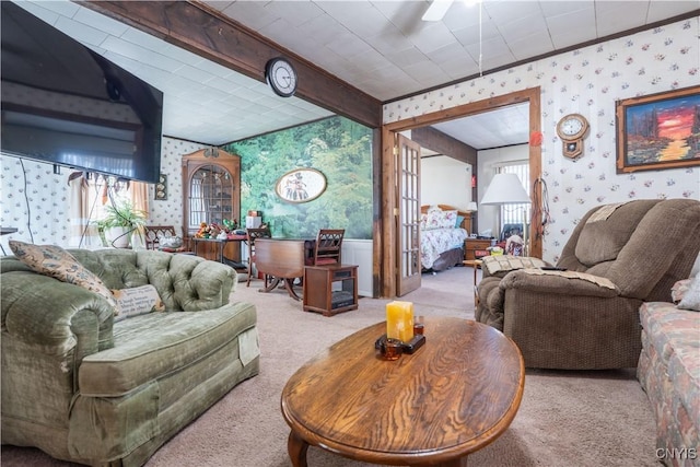 living area with beam ceiling, carpet flooring, and wallpapered walls