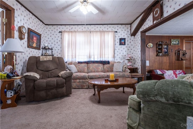 carpeted living area with wallpapered walls, a ceiling fan, and ornamental molding