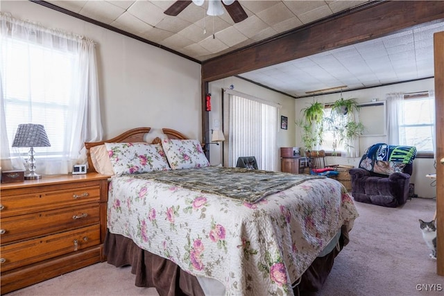 bedroom featuring beamed ceiling, carpet flooring, and a ceiling fan