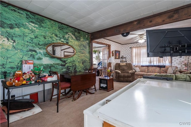 kitchen with wallpapered walls, beam ceiling, carpet flooring, and ceiling fan