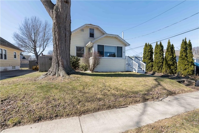 view of front of property with a front yard and fence