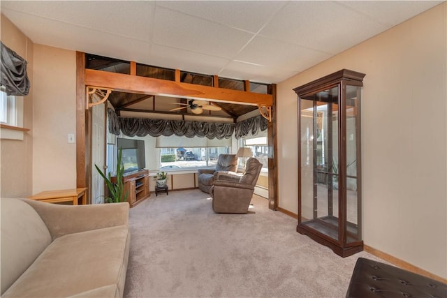 living area featuring lofted ceiling, carpet flooring, baseboards, baseboard heating, and ceiling fan