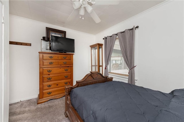 bedroom featuring a ceiling fan, carpet floors, and ornamental molding