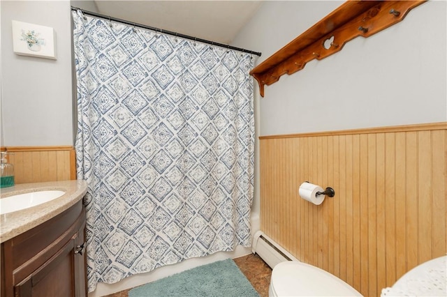 full bathroom with toilet, a baseboard heating unit, wooden walls, wainscoting, and vanity