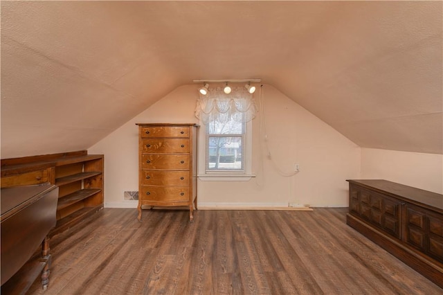 bonus room with vaulted ceiling, baseboards, and wood finished floors