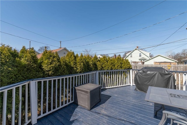 wooden terrace with a grill