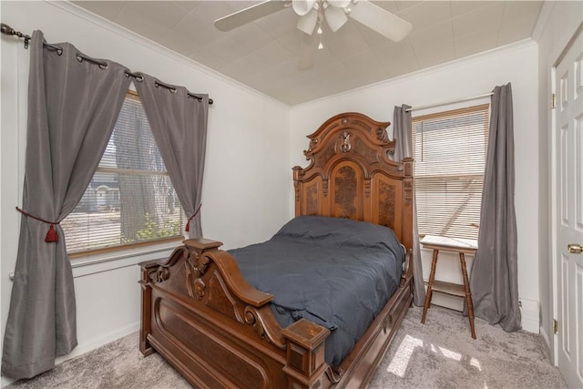 bedroom with ornamental molding, a ceiling fan, and carpet floors