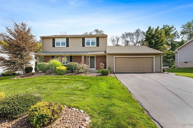 traditional home featuring aphalt driveway, an attached garage, brick siding, and a front yard