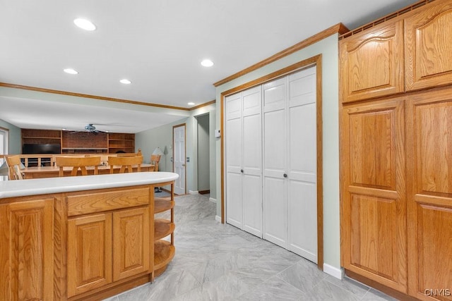 kitchen featuring crown molding, recessed lighting, baseboards, and light countertops