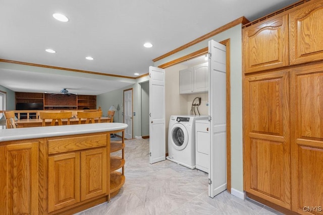 laundry area with recessed lighting, cabinet space, ornamental molding, and separate washer and dryer