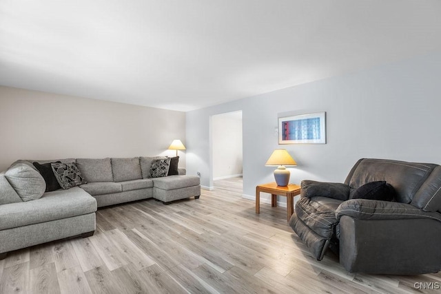 living area featuring light wood-style flooring and baseboards