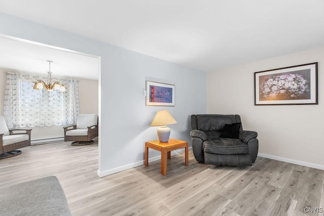 living area with a notable chandelier, light wood-style floors, baseboards, and baseboard heating