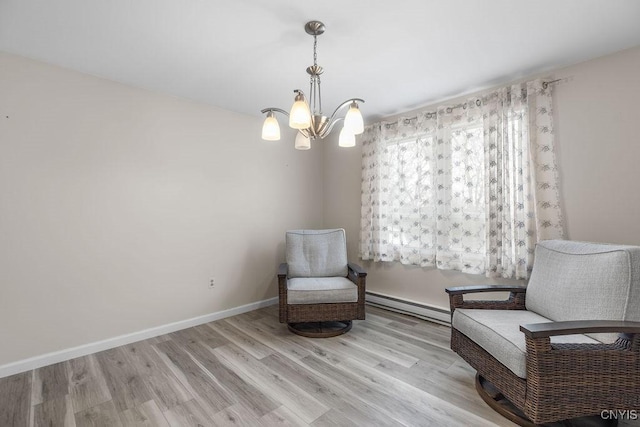 living area with a baseboard heating unit, an inviting chandelier, wood finished floors, and baseboards