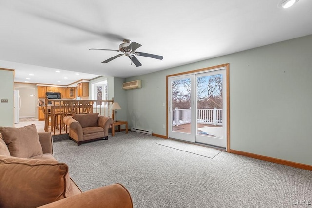 living area with a baseboard heating unit, baseboards, an AC wall unit, and a healthy amount of sunlight