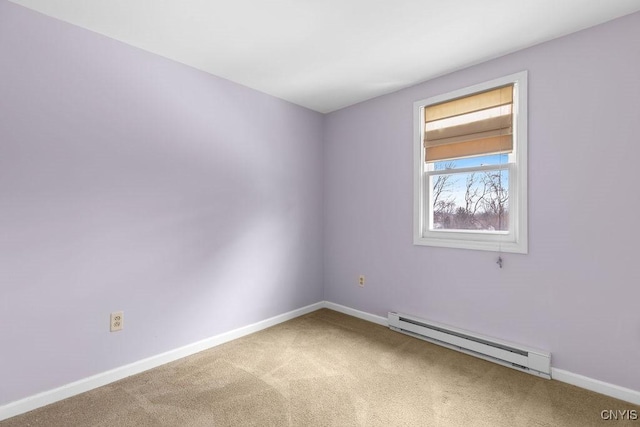 carpeted empty room featuring a baseboard radiator and baseboards