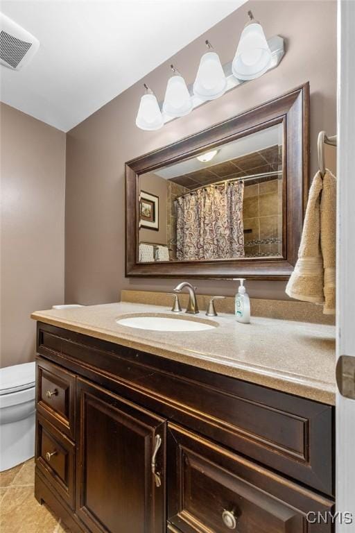 full bath featuring vanity, tile patterned floors, toilet, and visible vents