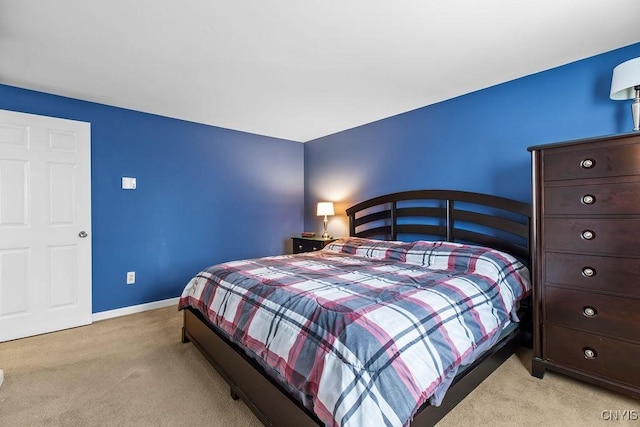 bedroom with light carpet and baseboards