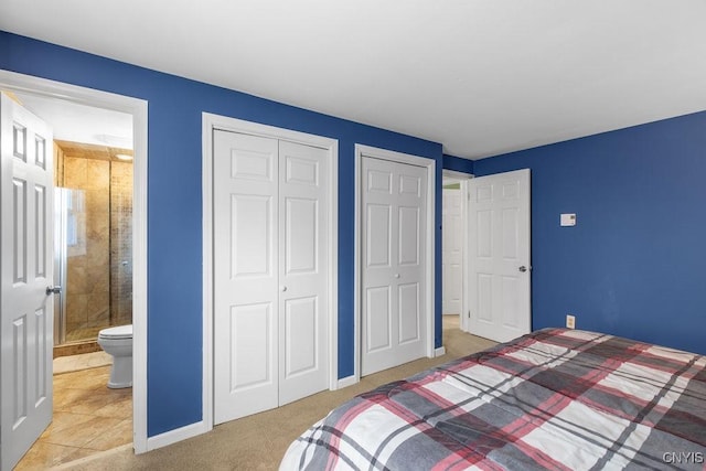 bedroom with baseboards, carpet, and ensuite bathroom