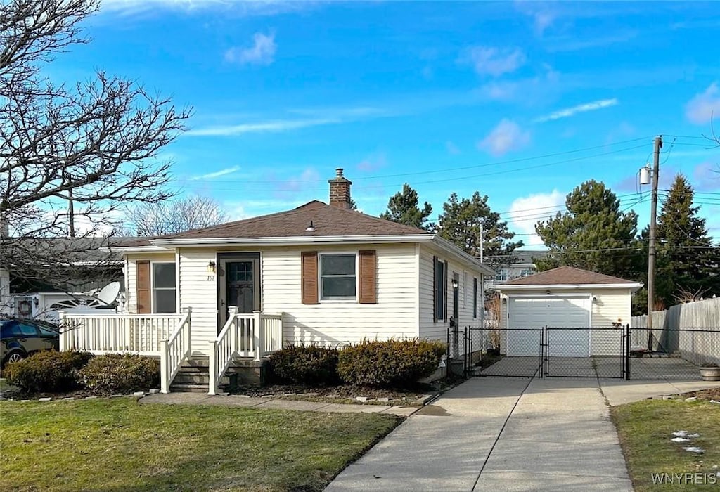 bungalow featuring an outbuilding, a gate, a detached garage, fence, and a chimney