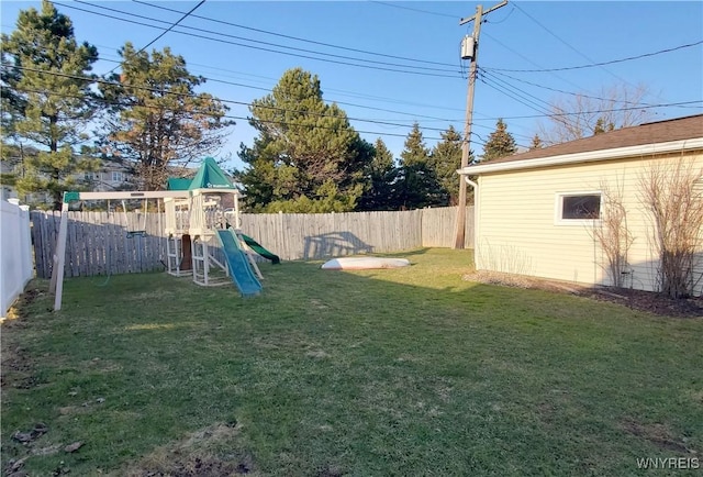 view of yard with a playground and a fenced backyard