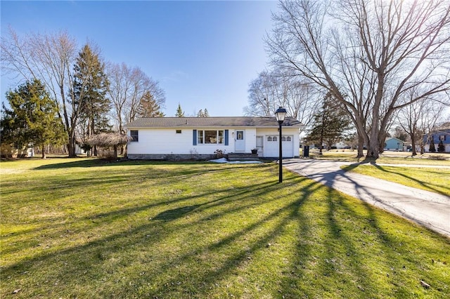 single story home featuring a garage, driveway, and a front lawn