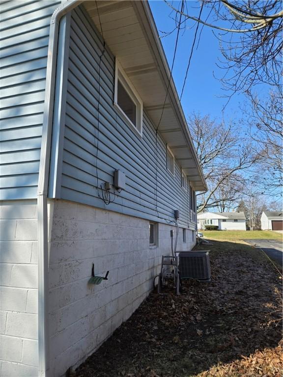 view of side of home featuring central AC