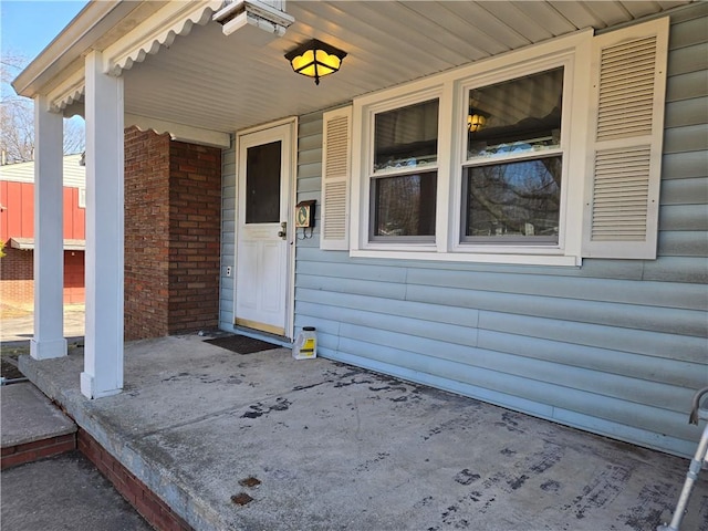 view of exterior entry with a porch