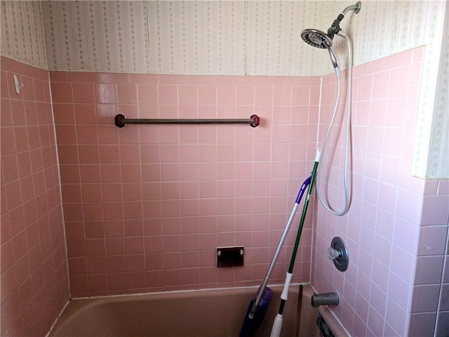 full bathroom featuring a wainscoted wall, wallpapered walls, and shower / tub combination