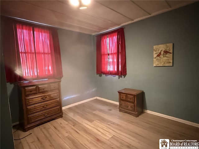 unfurnished bedroom with baseboards and wood finished floors