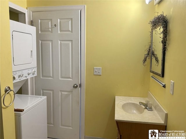 interior space featuring stacked washer and clothes dryer and vanity