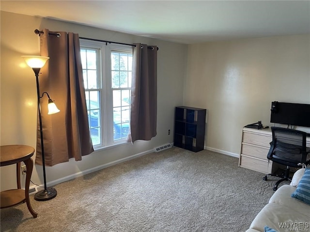 carpeted home office featuring visible vents and baseboards