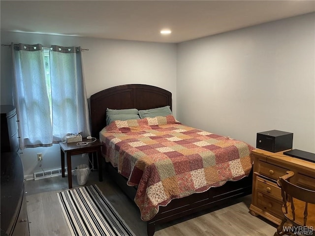 bedroom featuring visible vents and wood finished floors