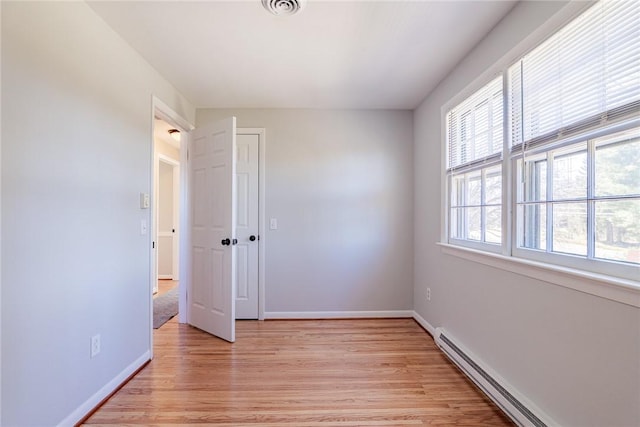 unfurnished bedroom with visible vents, baseboards, light wood-style flooring, a closet, and a baseboard radiator