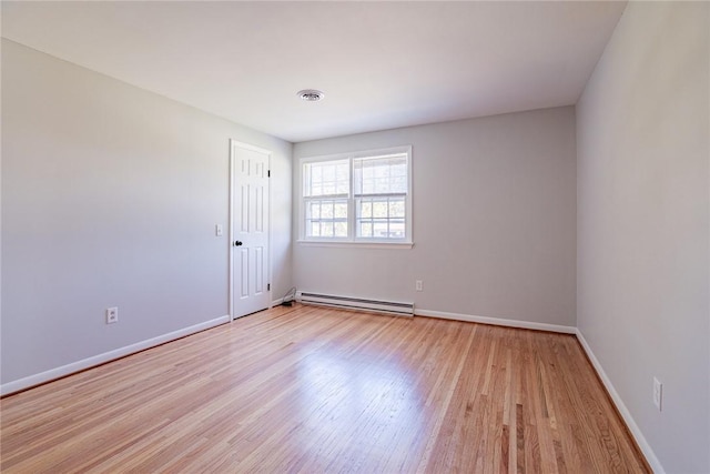 empty room with a baseboard radiator, baseboards, visible vents, and light wood-style flooring