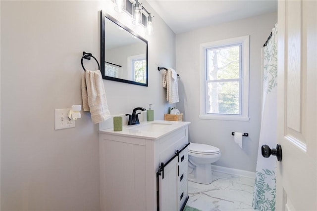 full bathroom featuring toilet, marble finish floor, vanity, and a healthy amount of sunlight