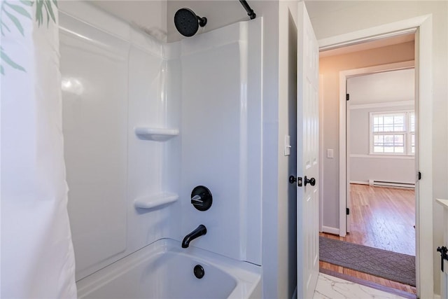 bathroom featuring baseboard heating and  shower combination