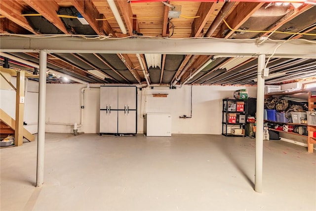 unfinished basement with fridge